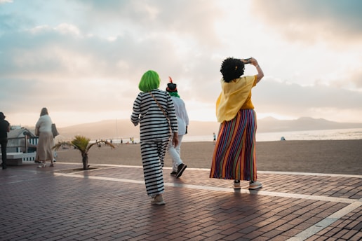 A couple of people that are walking down a street