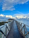 A long pier stretches out into the ocean