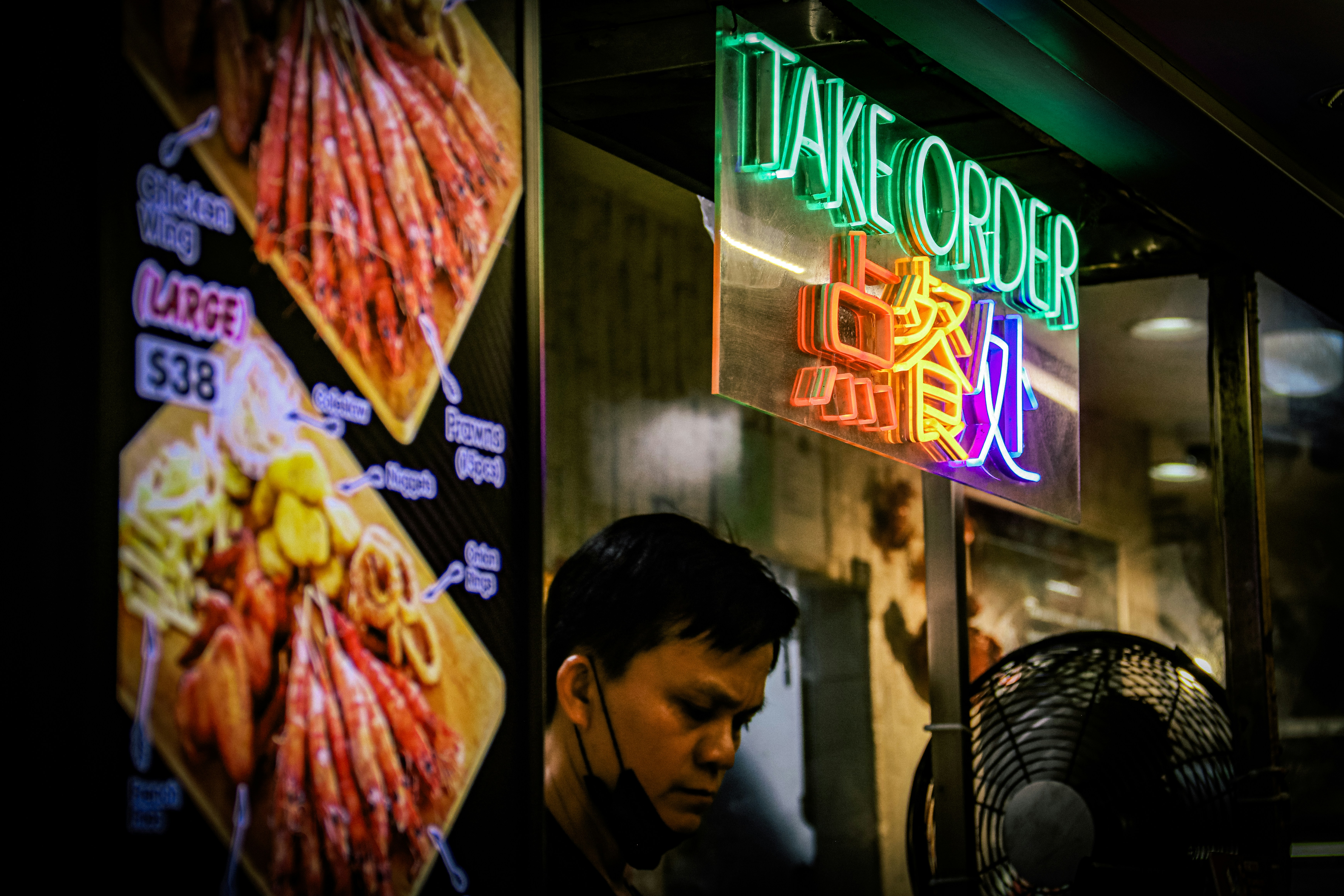 A man standing outside of a chinese restaurant