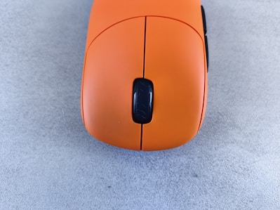 A computer mouse sitting on top of a gray floor