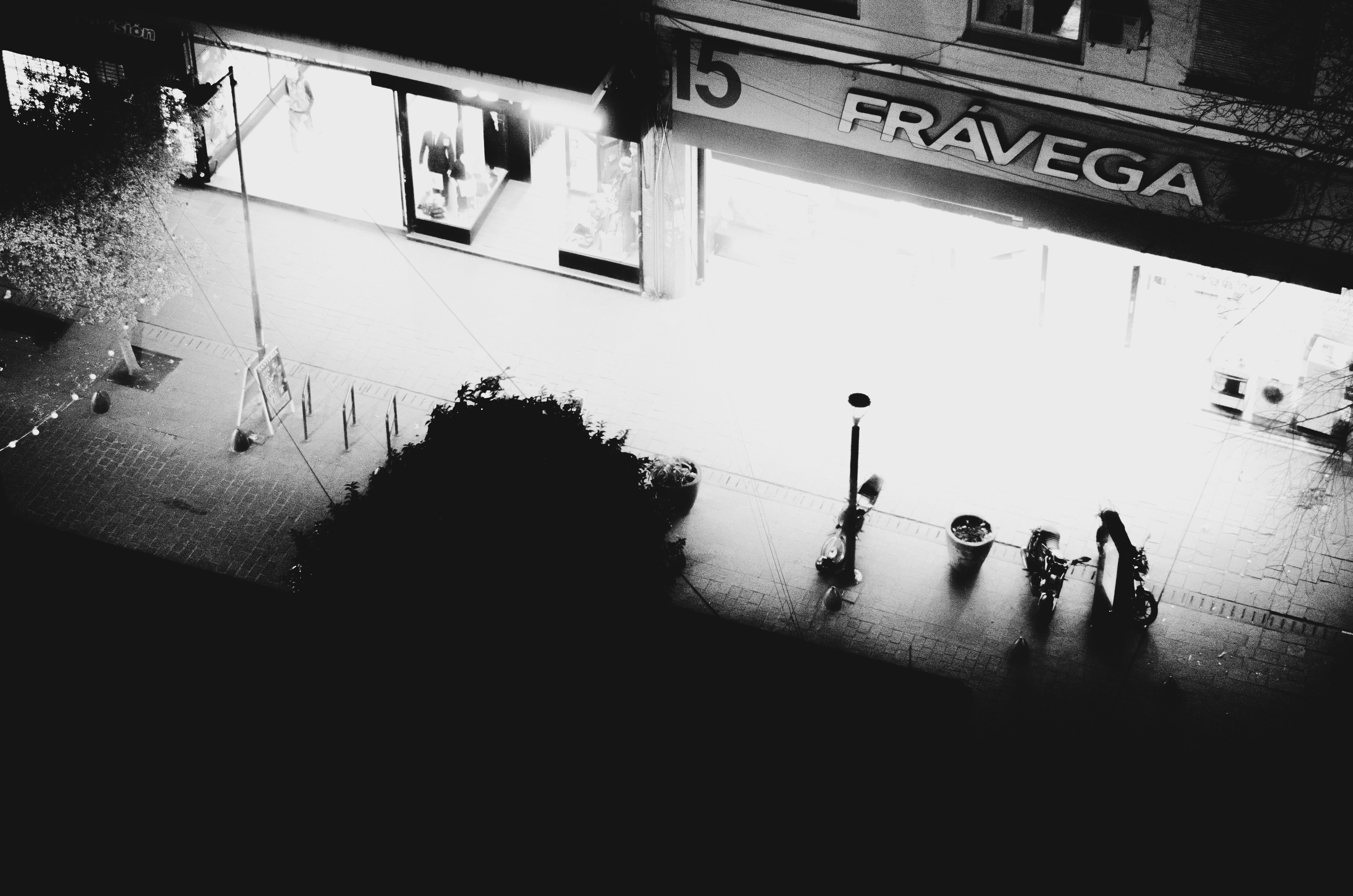 A black and white photo of a building at night