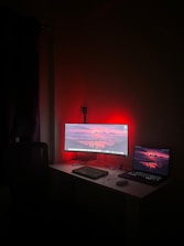 A desk with a computer and a laptop on it