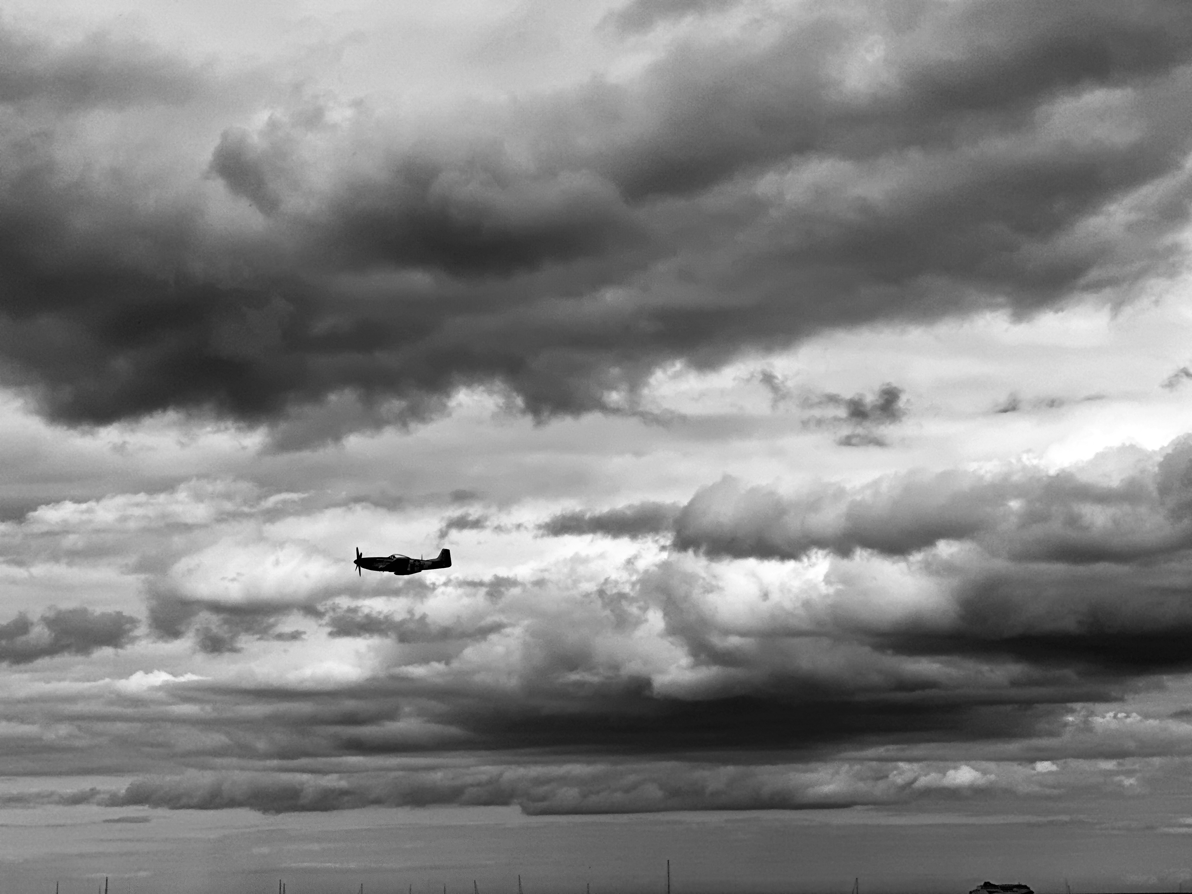 A black and white photo of a plane in the sky, Bray Air show