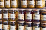 Jars of honey sit on a shelf in a store