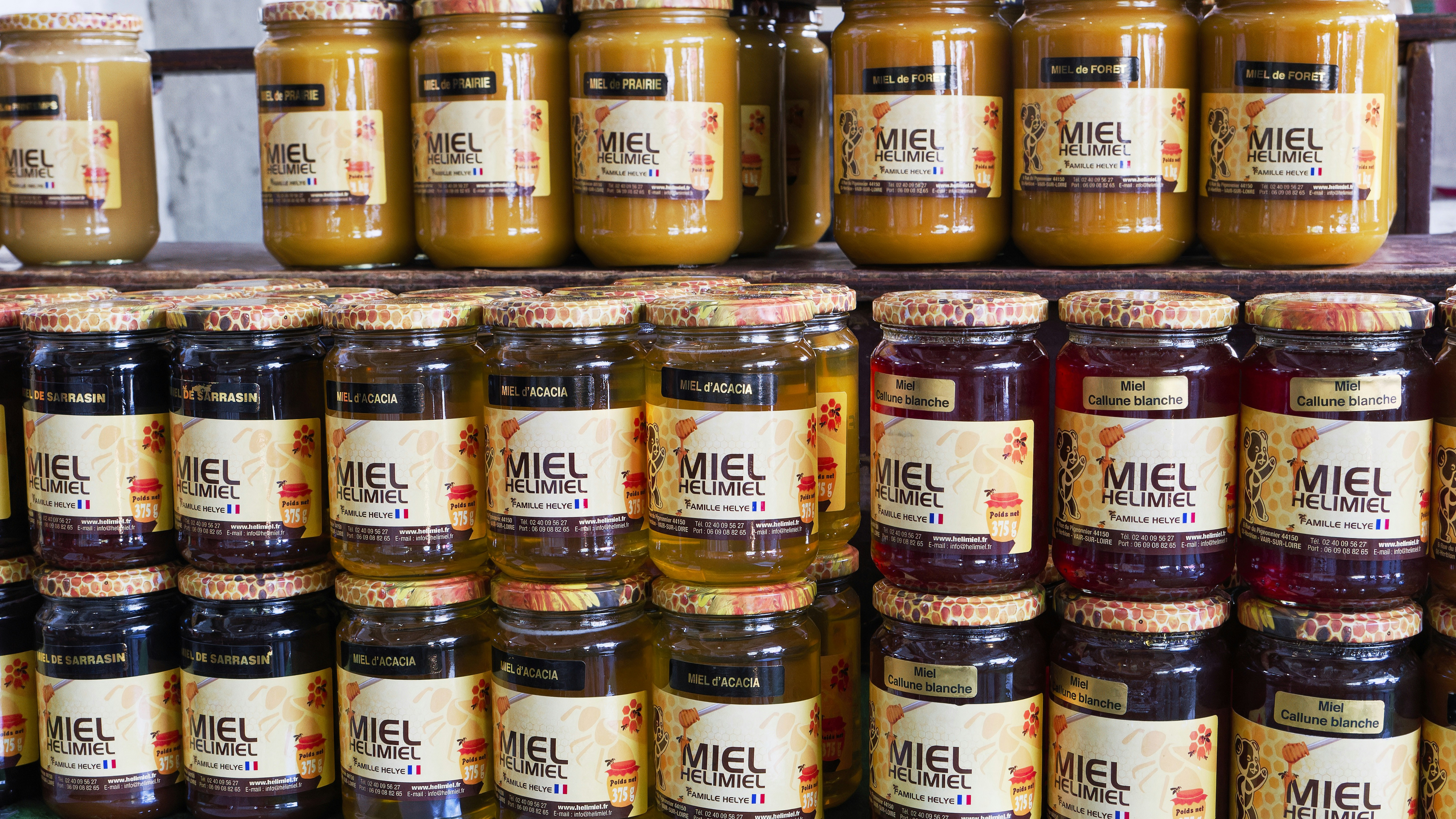 A shelf filled with lots of jars of food