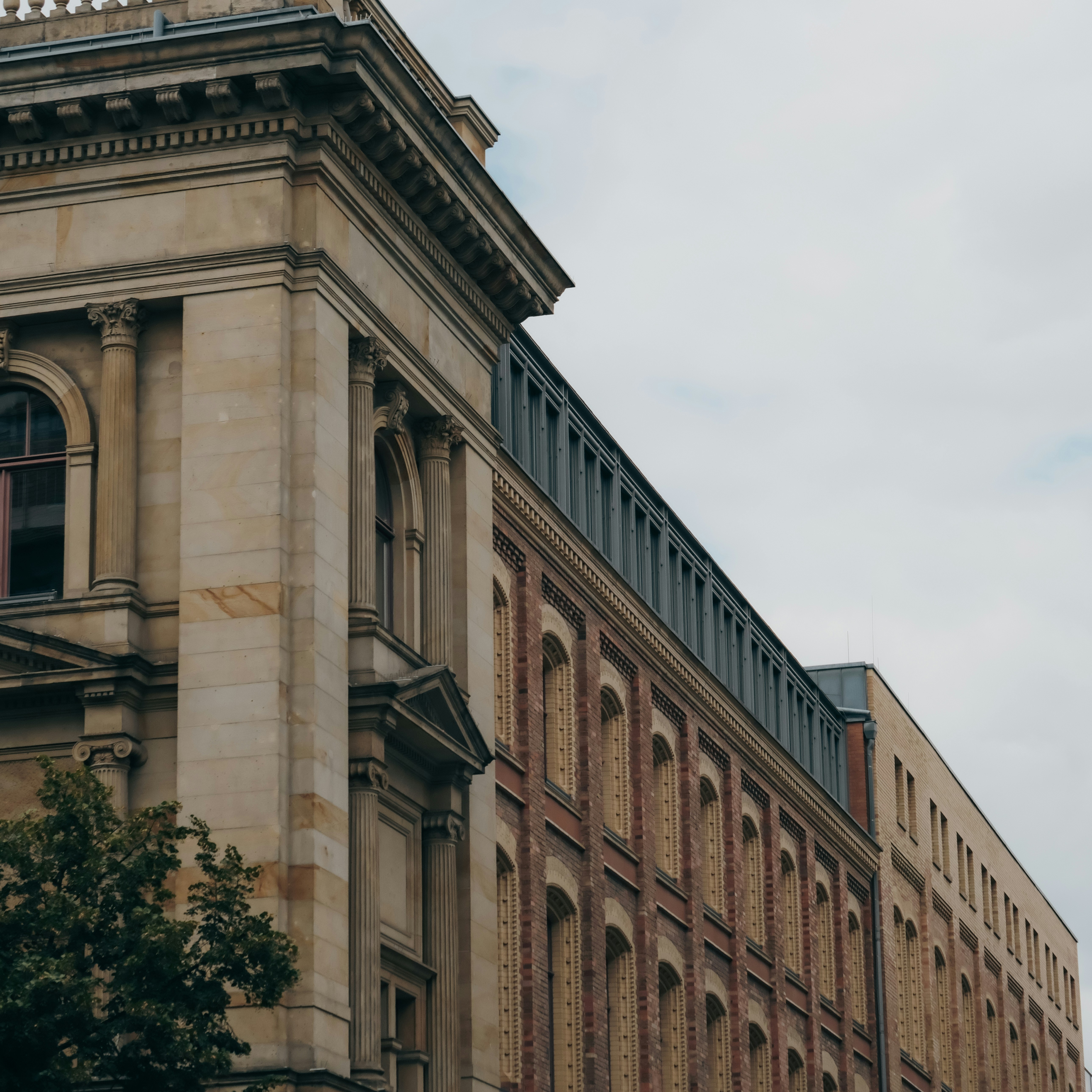 A tall building with a clock on the top of it - a-tall-building-with-a-clock-on-the-top-of-it-Tx4ADsfXcJA