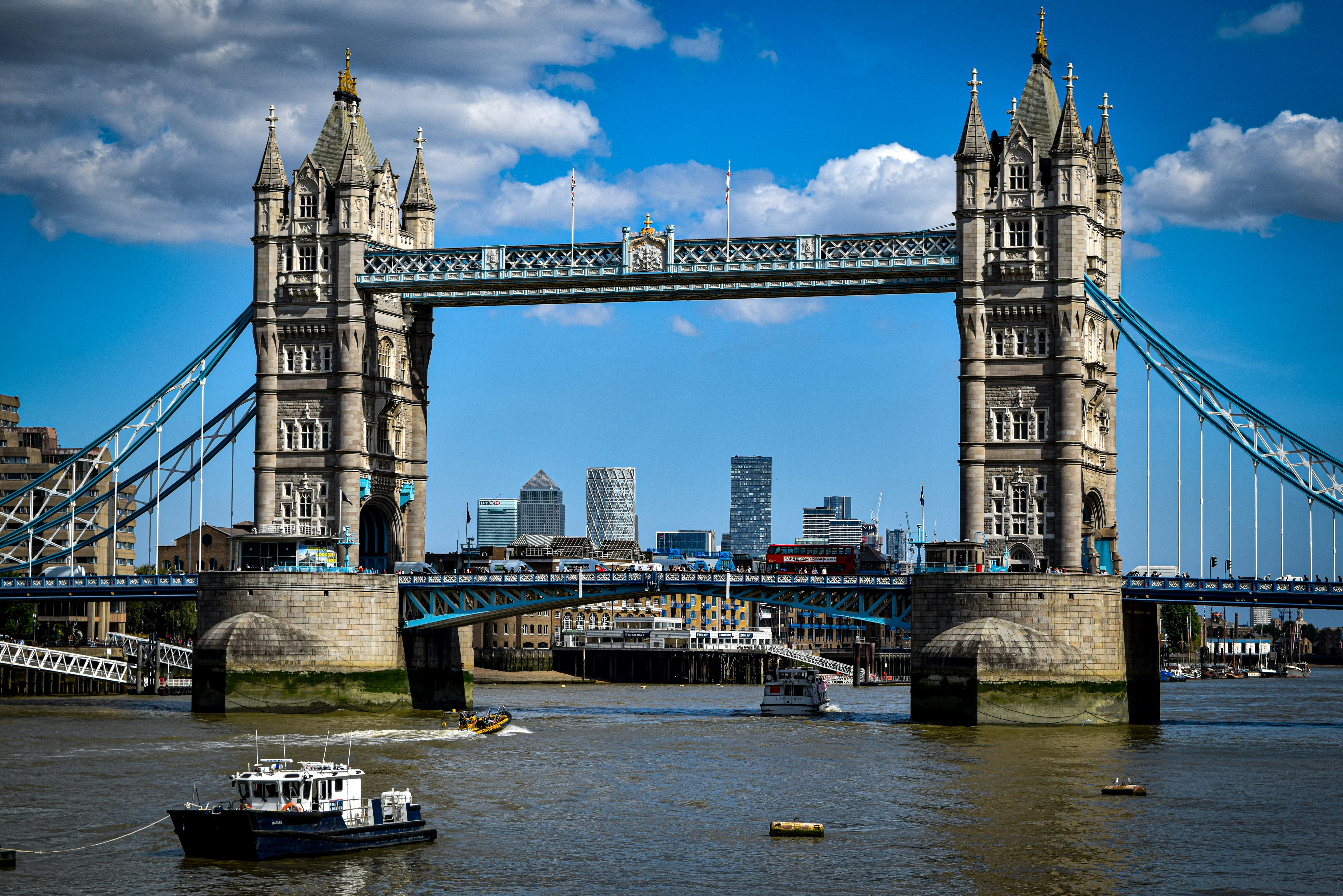 A boat is in the water near a bridge