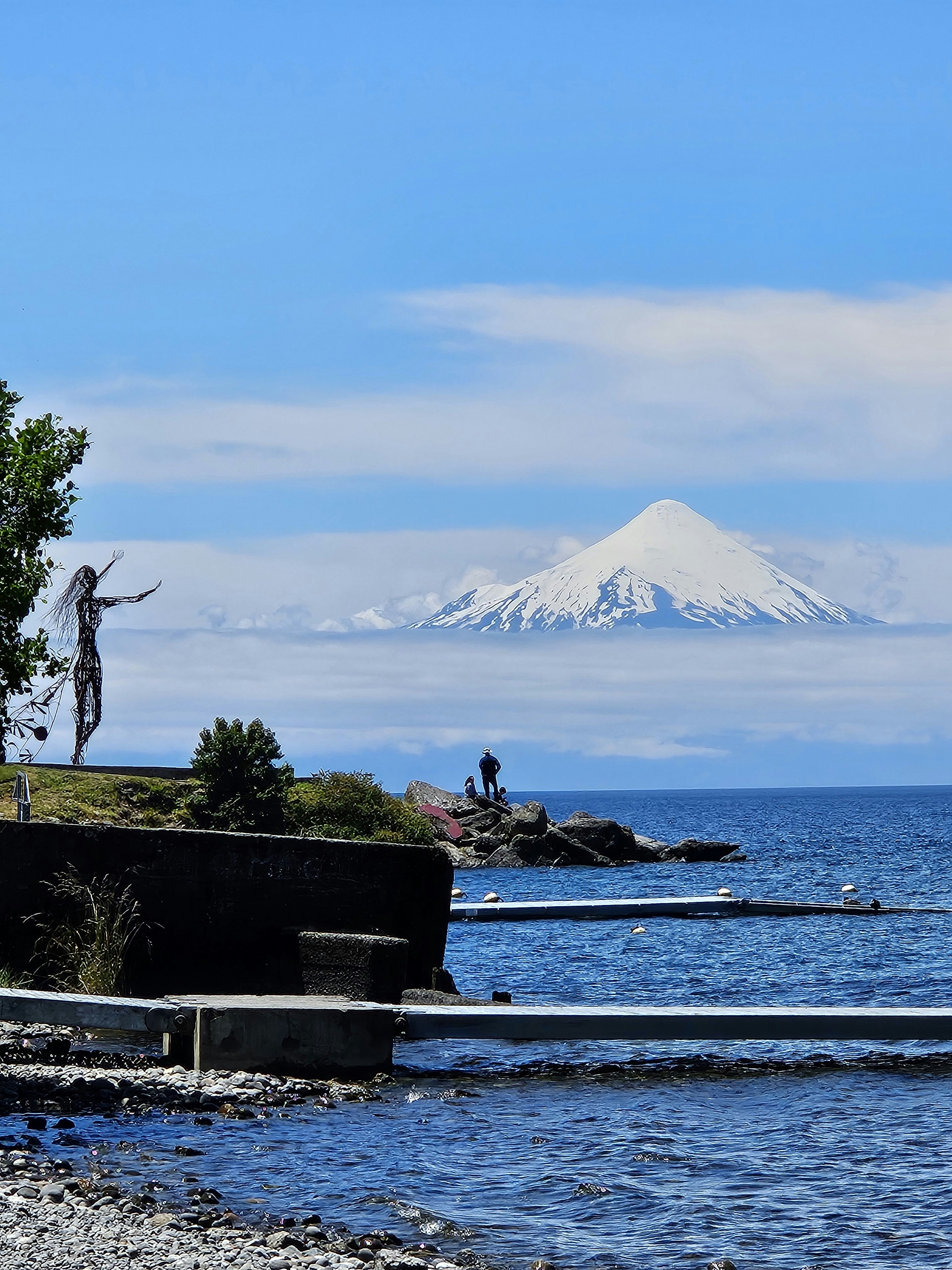 A body of water with a mountain in the background