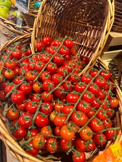 A display of tomatoes in baskets in a grocery store