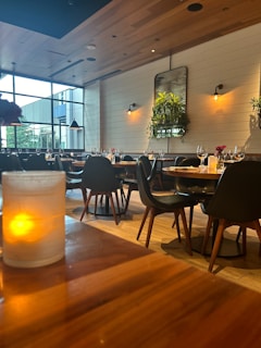 A restaurant with tables and chairs and a large window