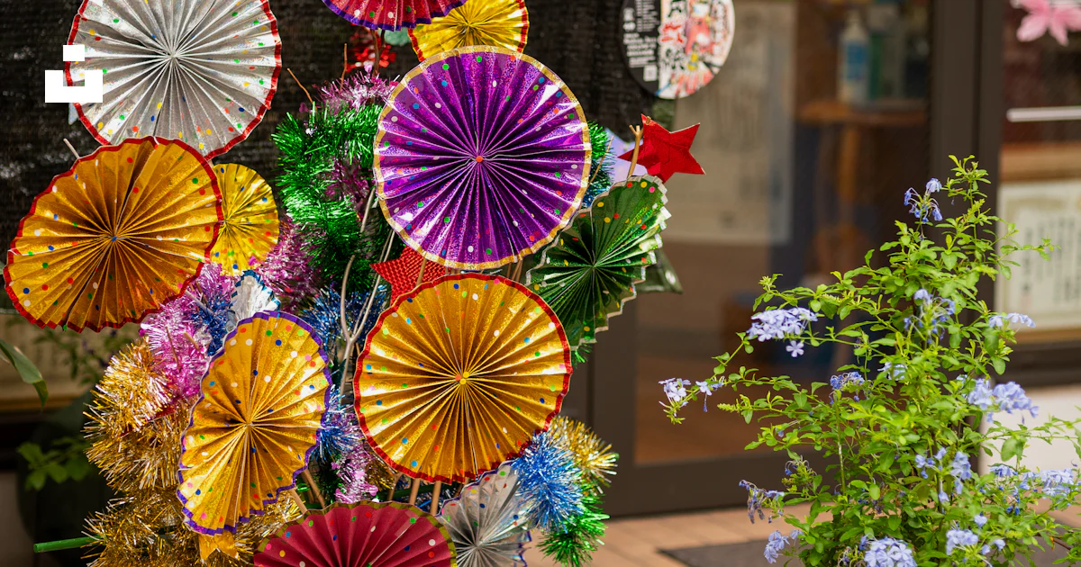 A display of colorful paper fans in a store window photo – Free Flower ...