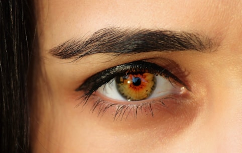 A close up of a person's eye with long lashes