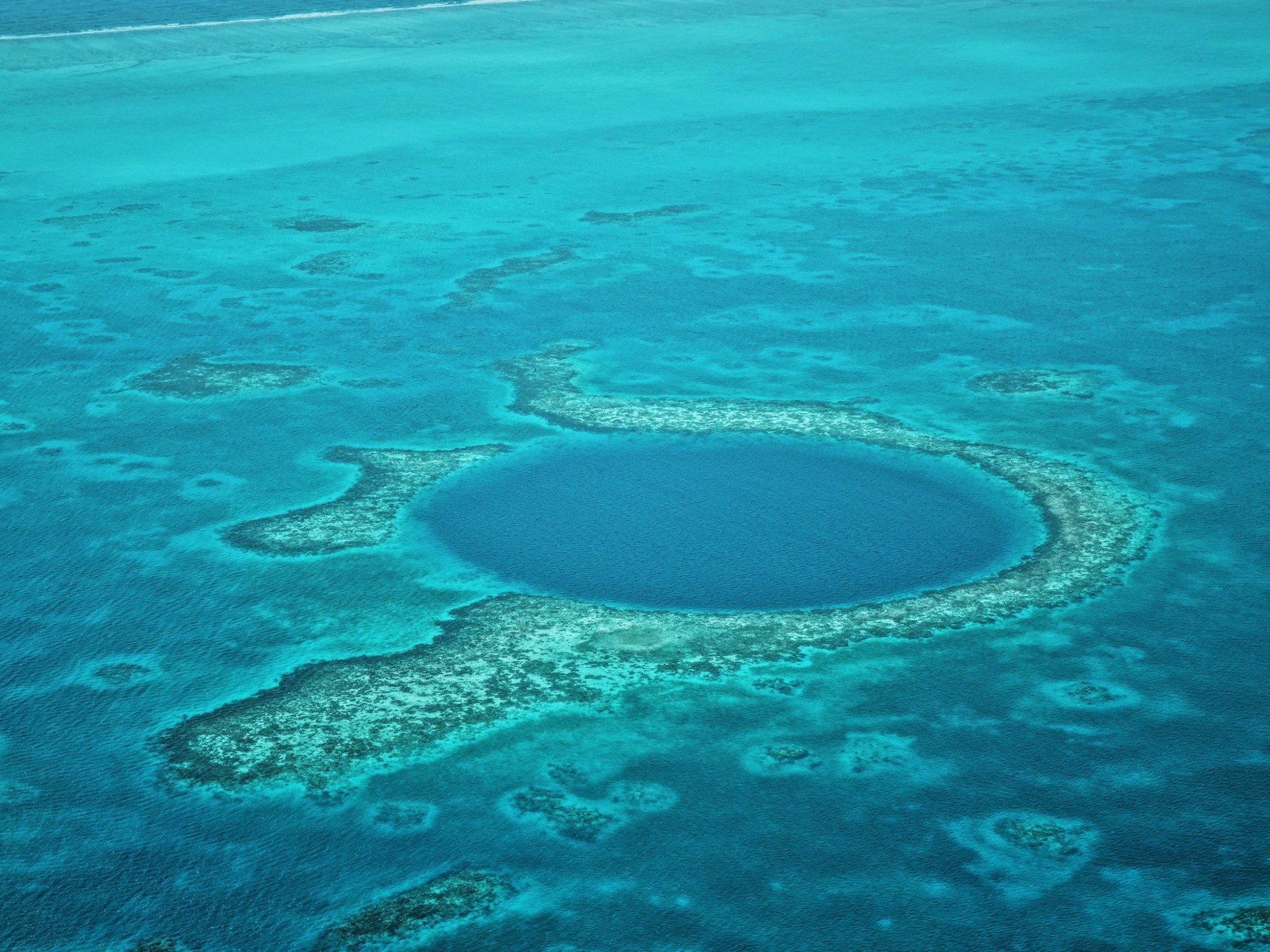 A large blue hole in the middle of the ocean