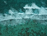 An aerial view of the ocean with waves