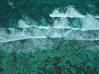 An aerial view of the ocean with waves