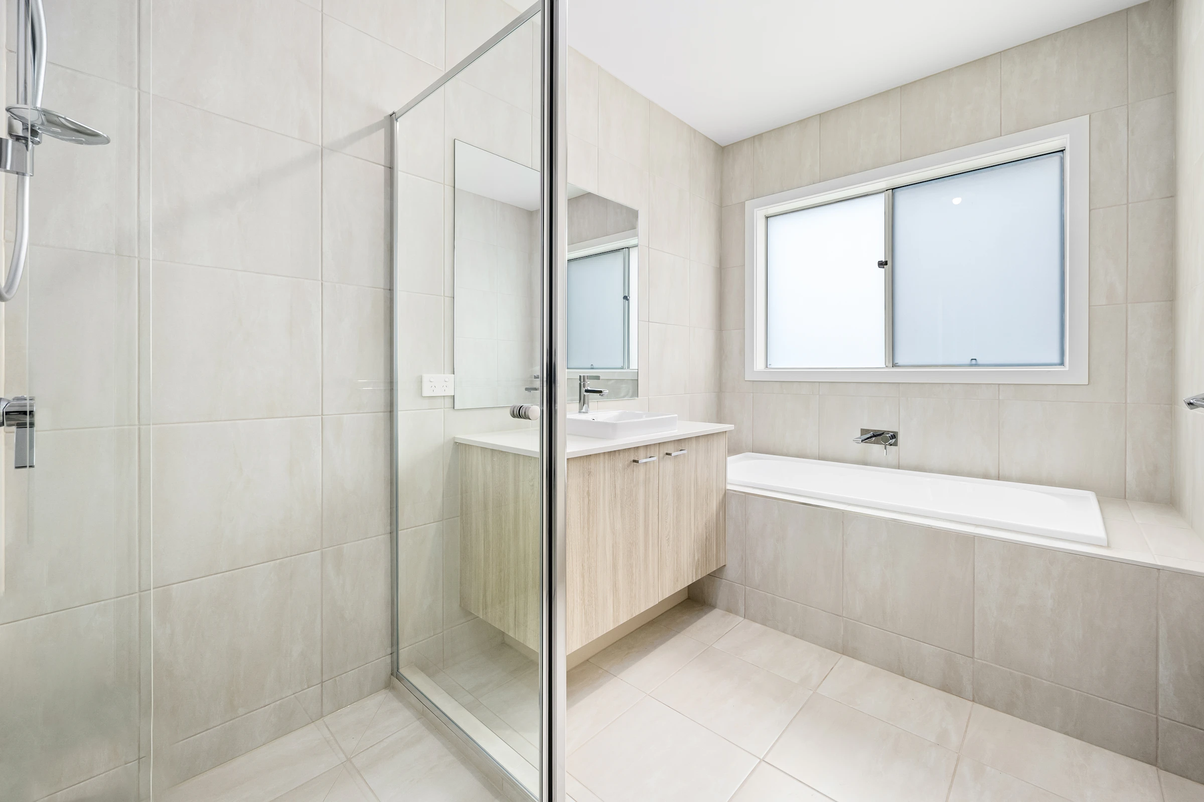 Modern white bathroom with glass shower door