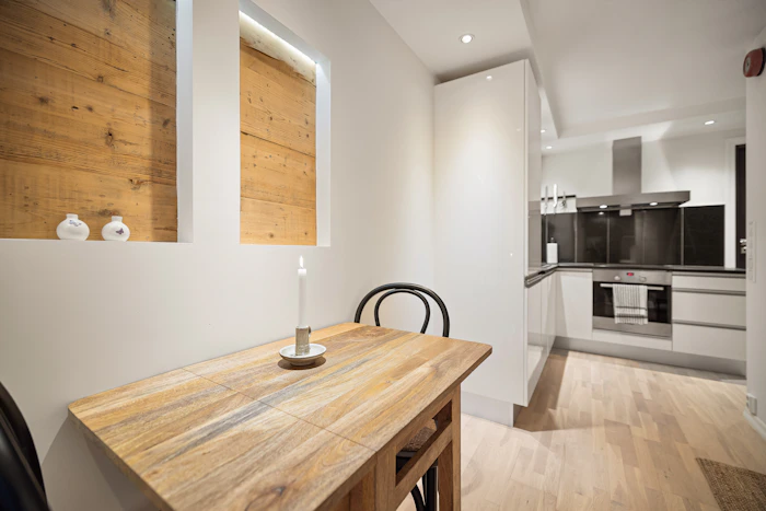 A wooden dining table with chairs in a bright home