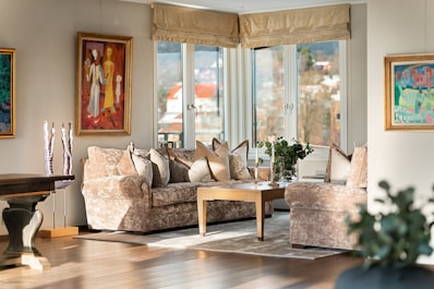 A living room filled with furniture and a painting on the wall