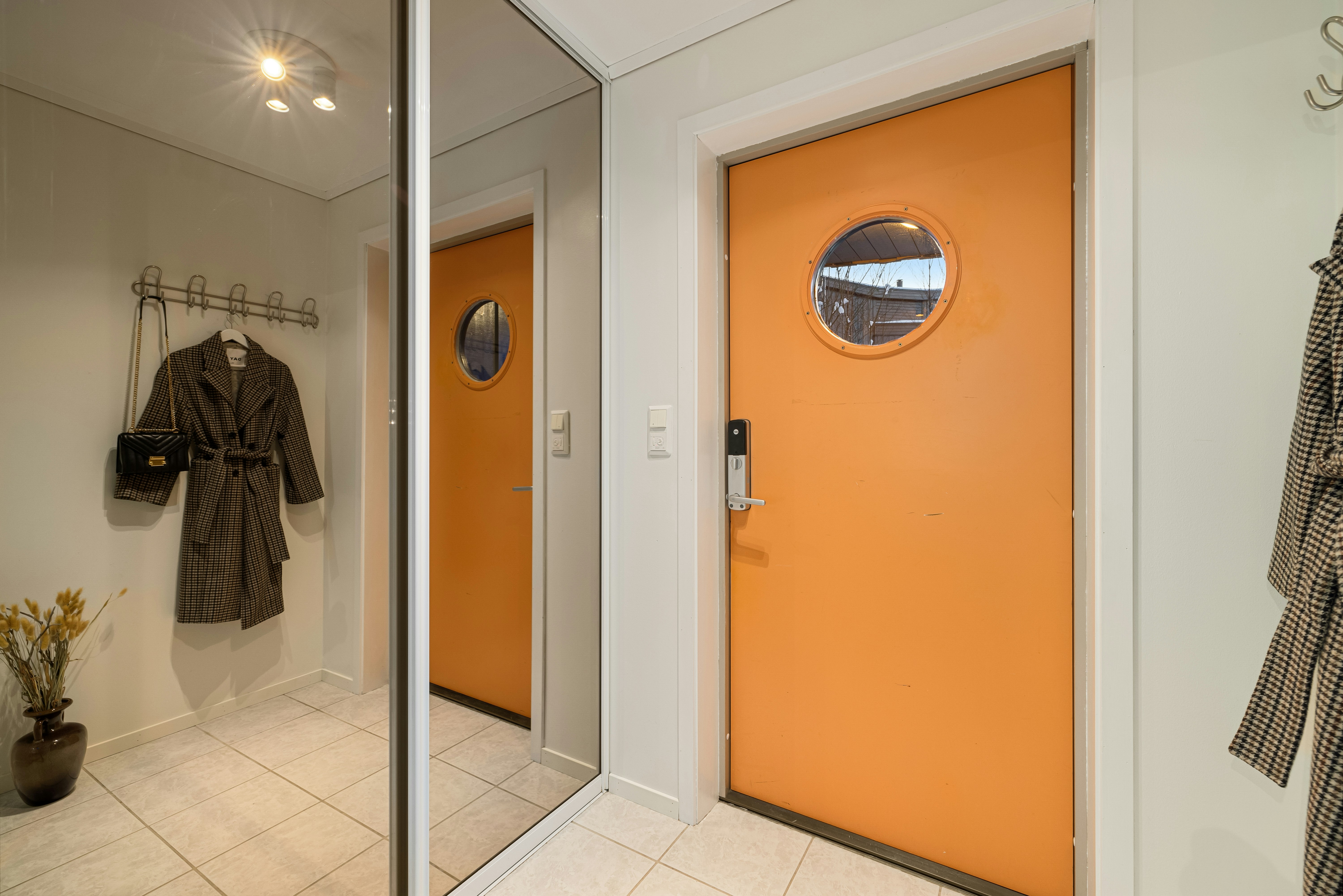 A bathroom with a yellow door and a mirror
