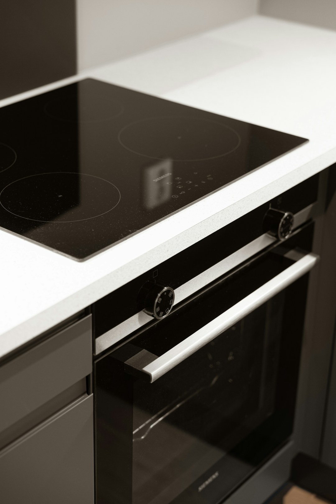 Glass cooktop installed above a built-in electric oven
