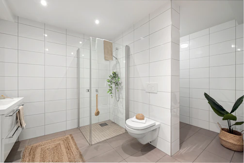A bathroom with a toilet, sink, and shower