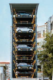 A tall tower of cars in a parking lot
