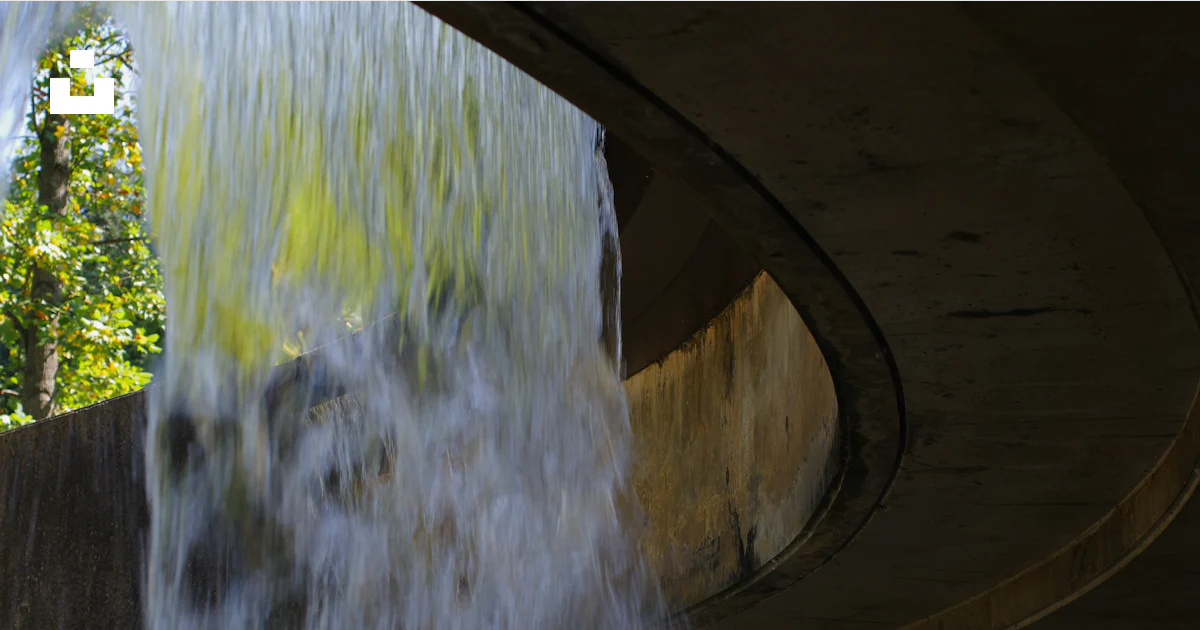 A water fall coming out of a pipe photo – Free Waterfall Image on Unsplash