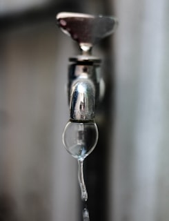 Water dripping from a leaking tap