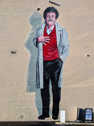 A painting of a man with a red shirt and black pants