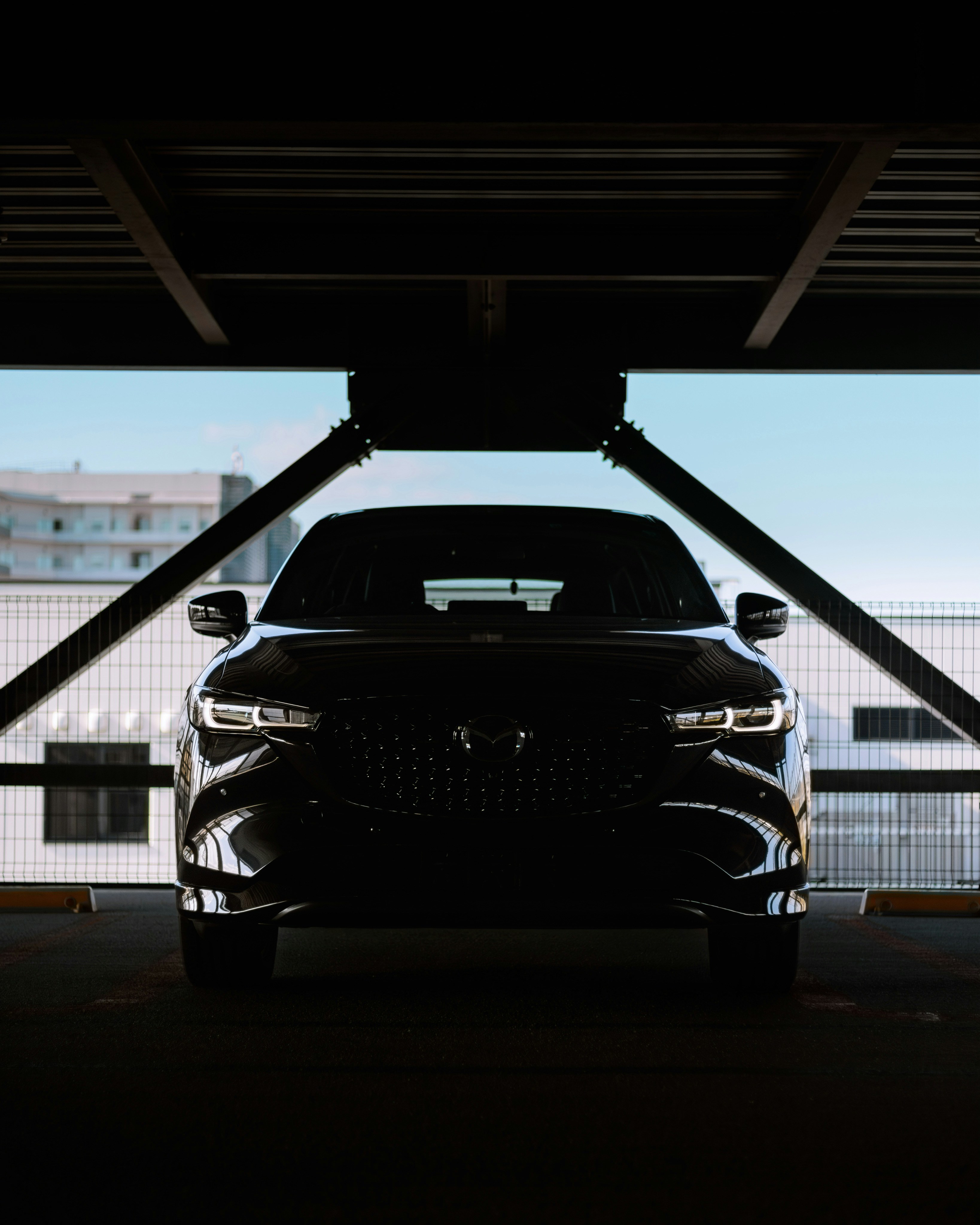 A black car parked in a parking garage