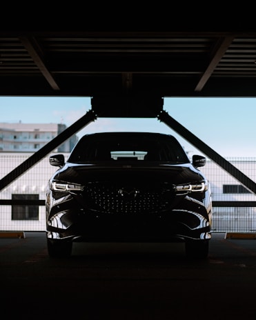 A black car parked in a parking garage
