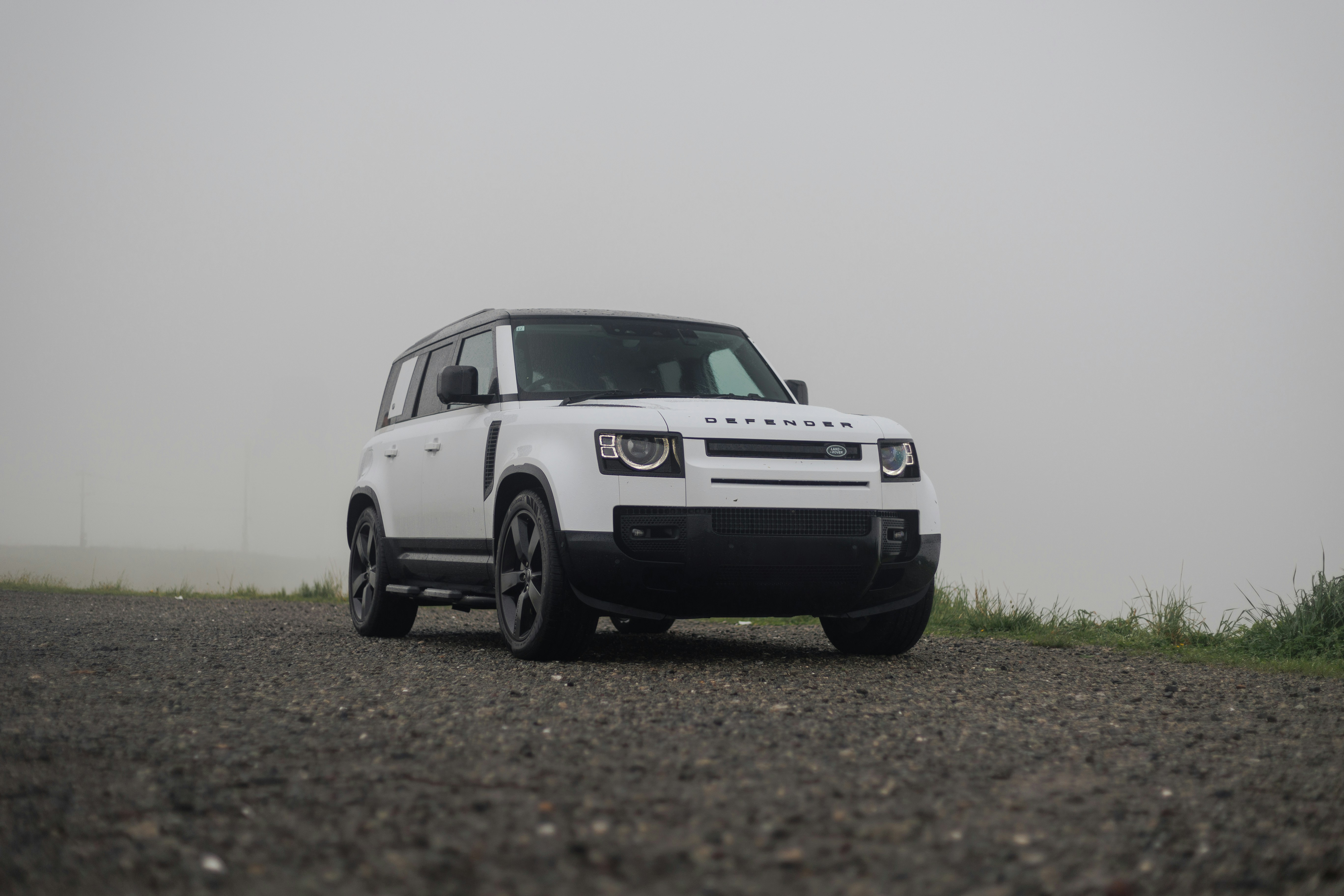 A white truck parked on a gravel road