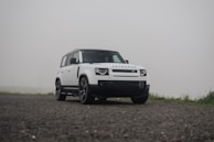 A white truck parked on a gravel road