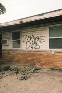 A house with graffiti written on the side of it