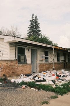 A pile of trash sitting in front of a house