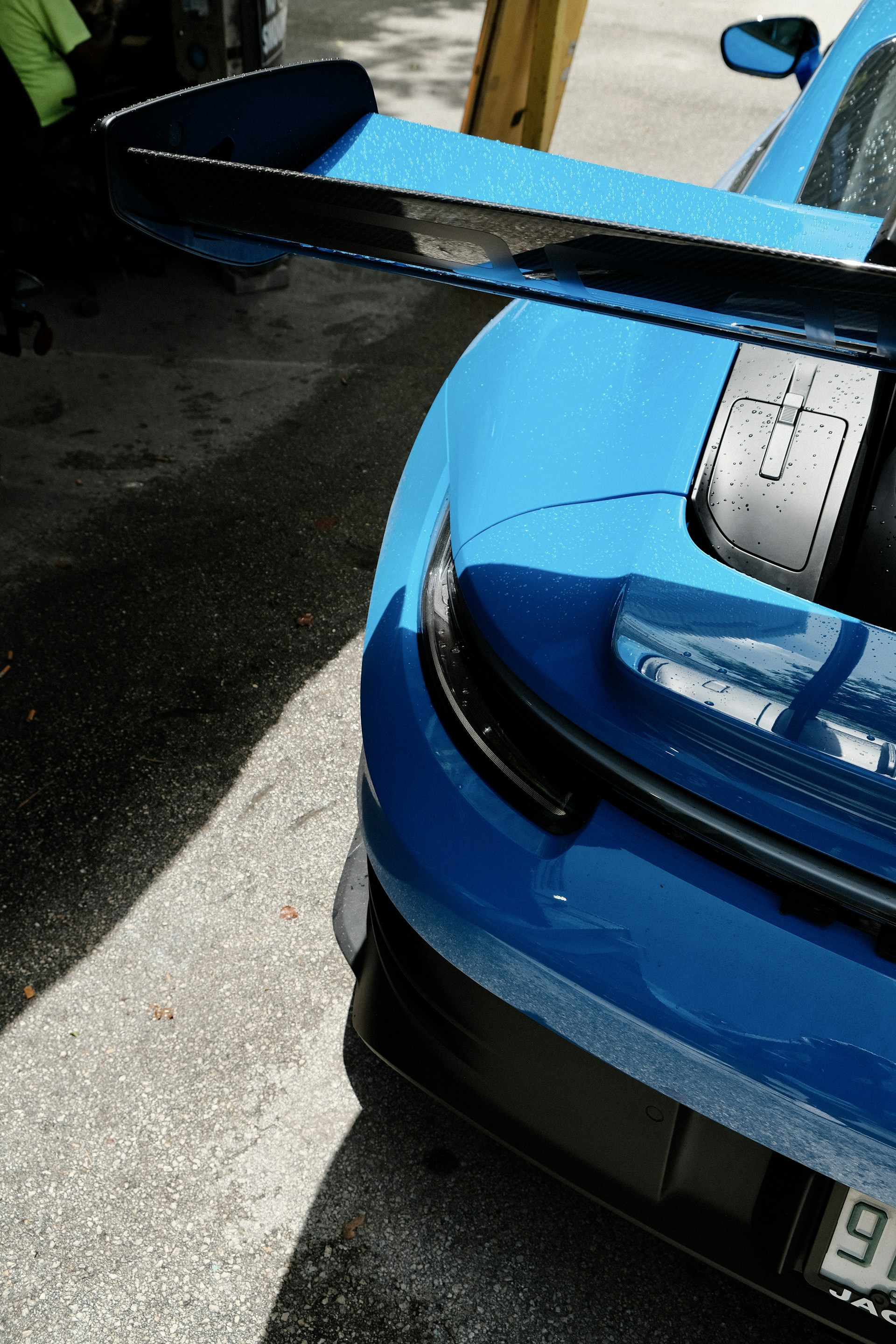 A blue sports car parked on the side of the road