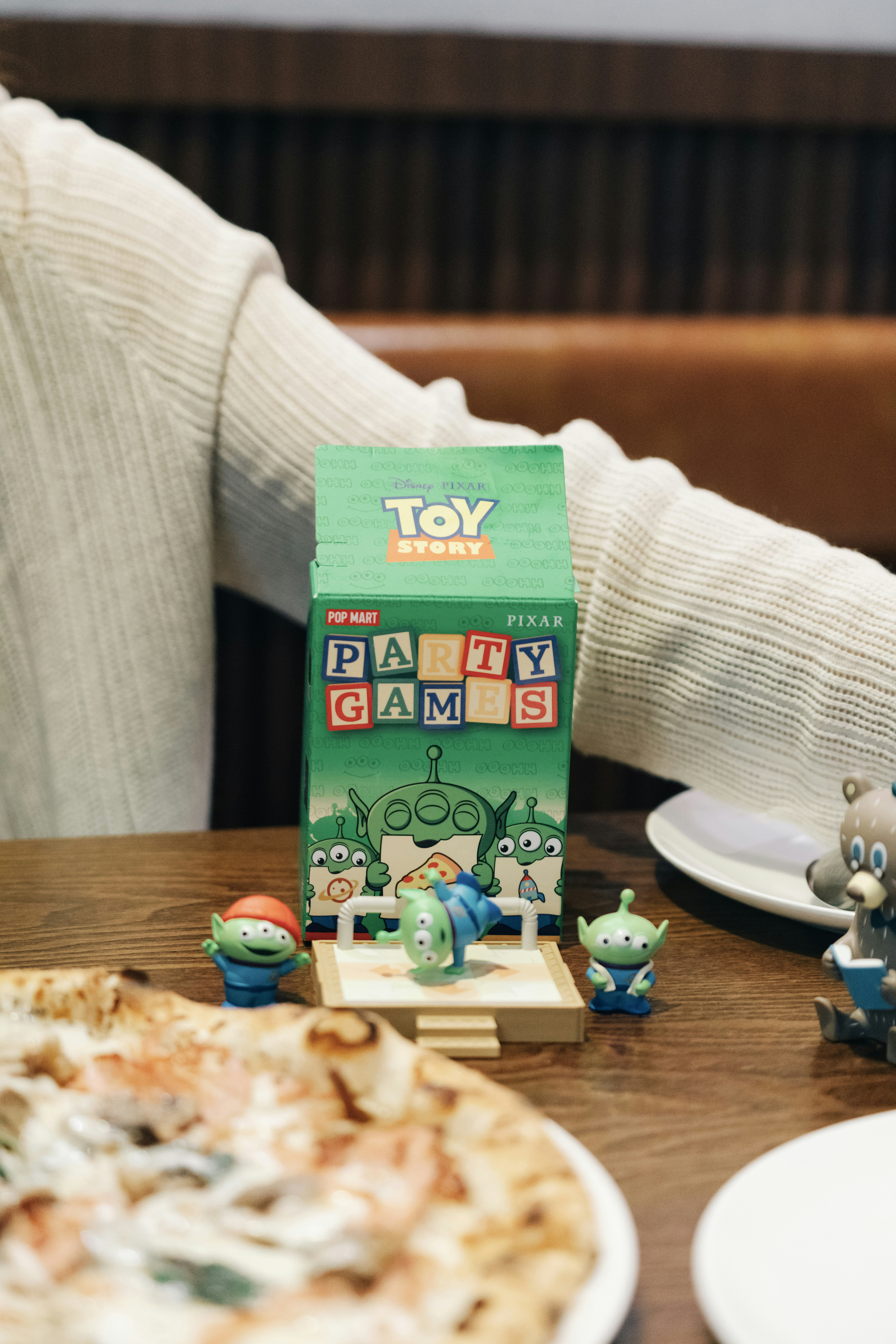 A person sitting at a table with a pizza