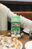 A person sitting at a table with a pizza