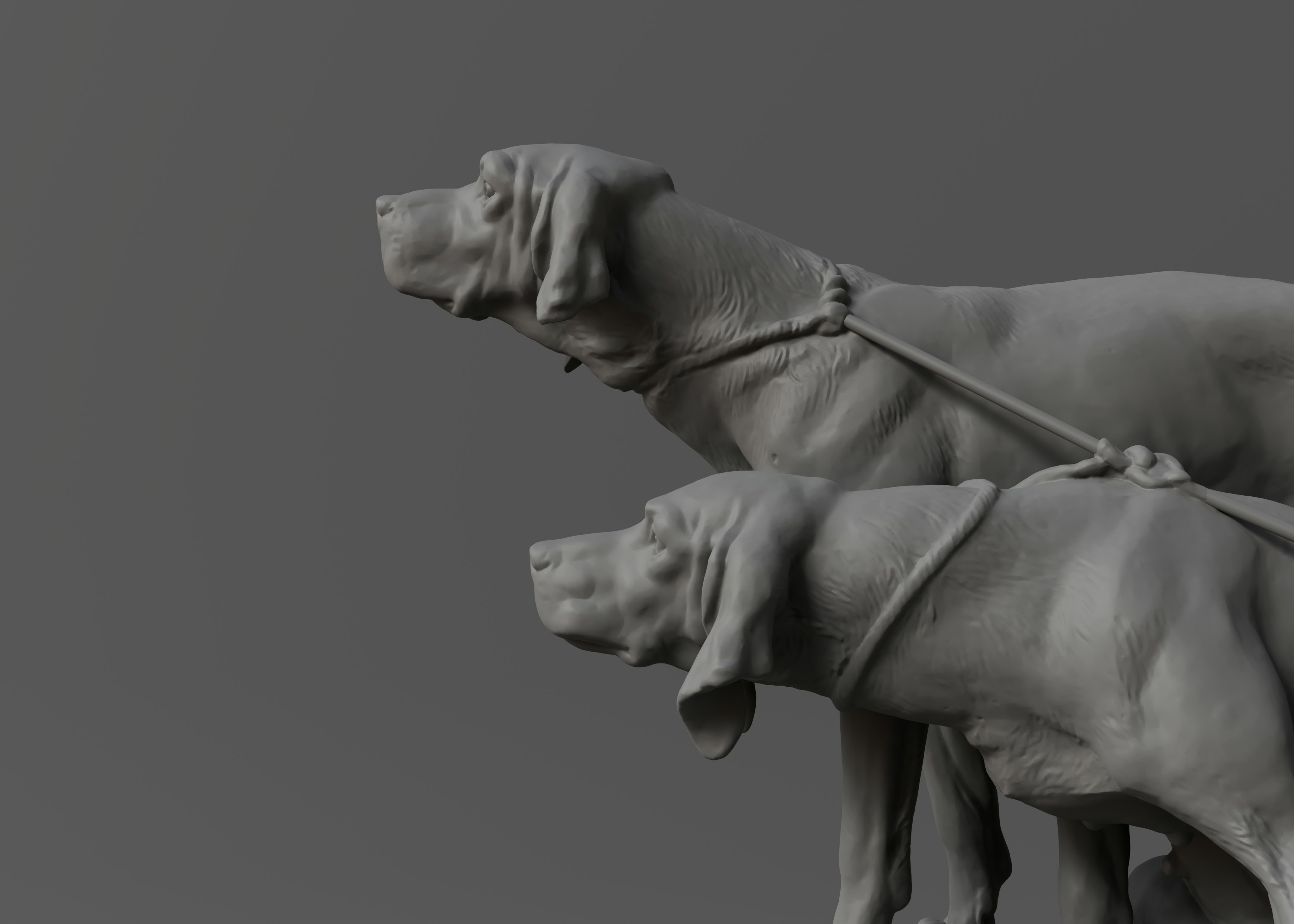 A statue of two dogs on a leash