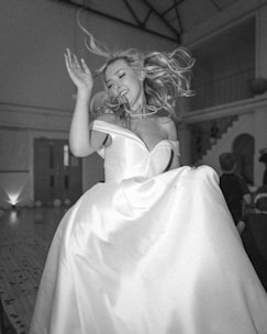 A woman in a white dress is dancing