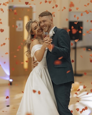 A bride and groom are posing for a picture