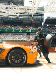 side view of an orange sports car on performance tyres sold in nigeria at tyrepublic