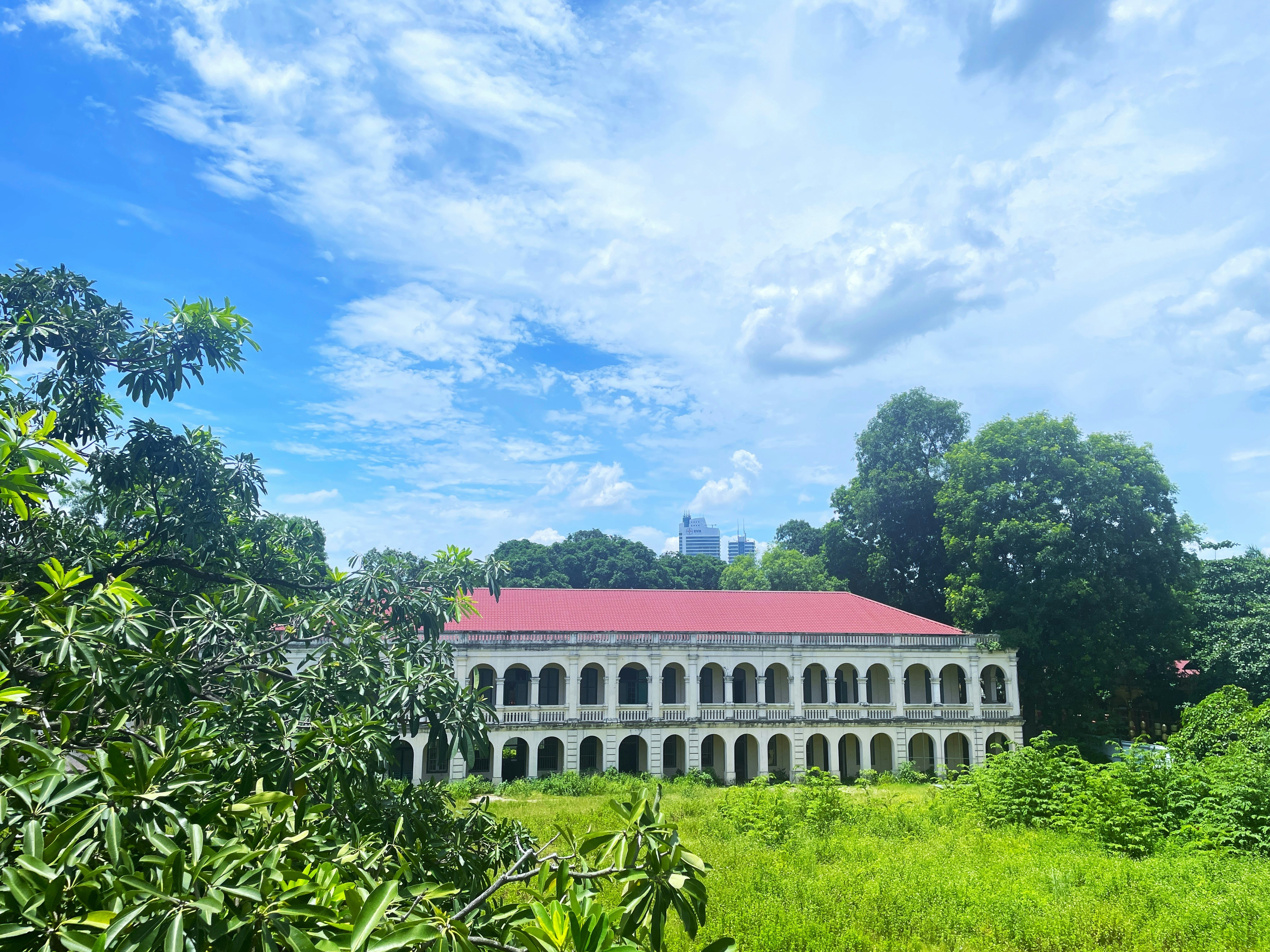 A large building sitting in the middle of a lush green field, Imperial Citadel of Thang Long, Hanoi, Vietnam