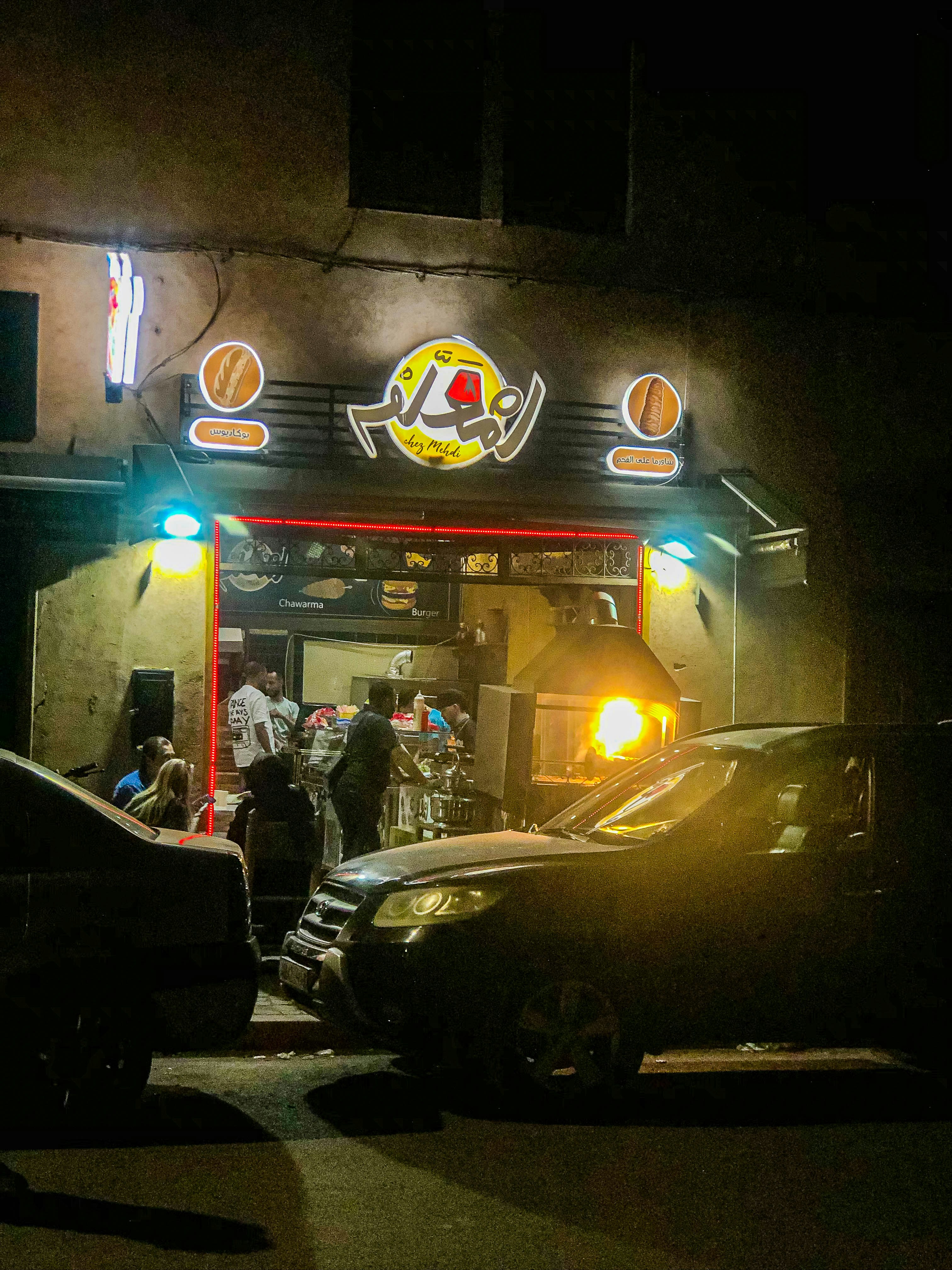 A group of cars parked in front of a restaurant