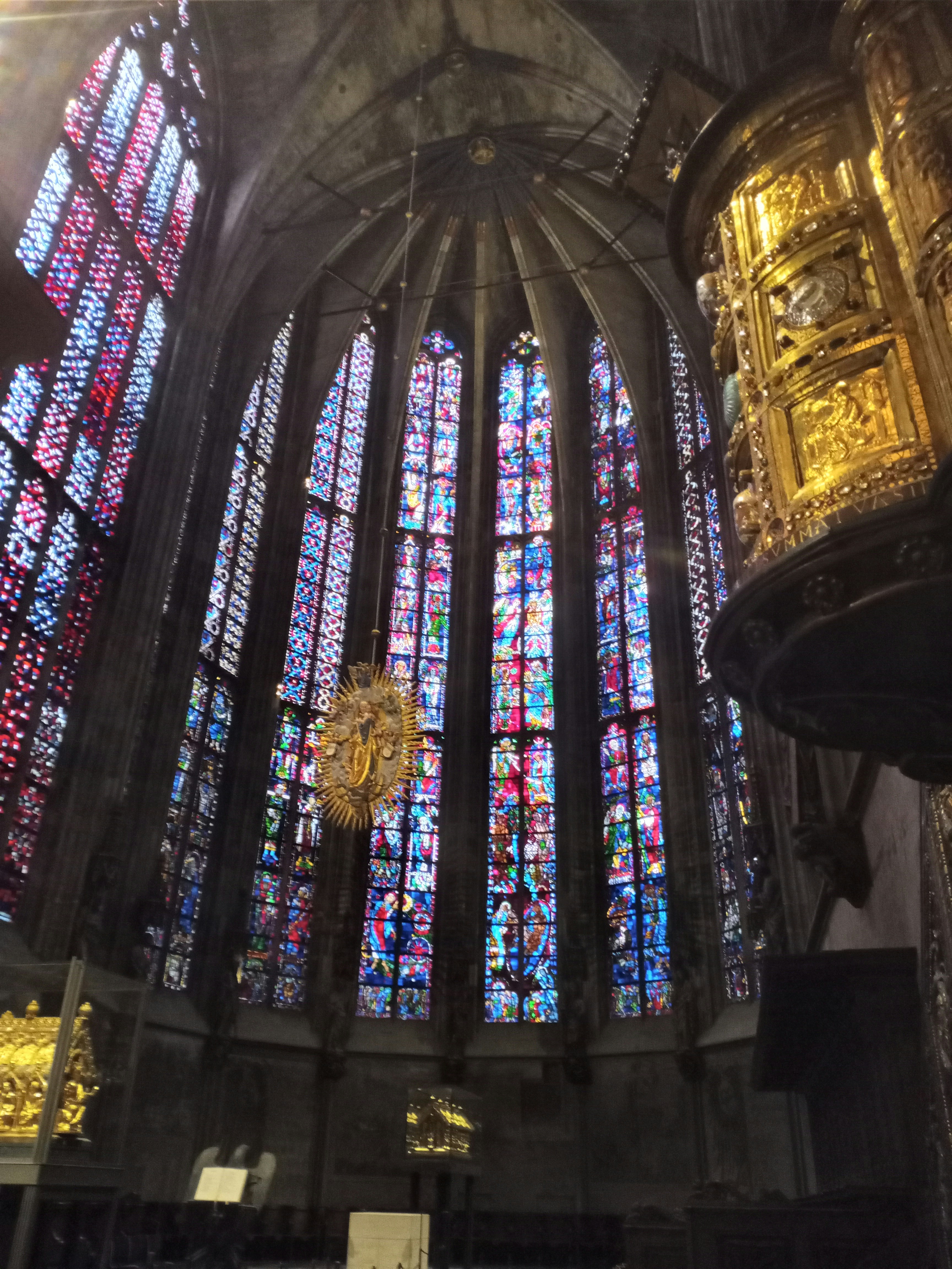 A large cathedral with a chandelier and stained glass windows