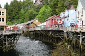 A river running through a small town next to tall buildings