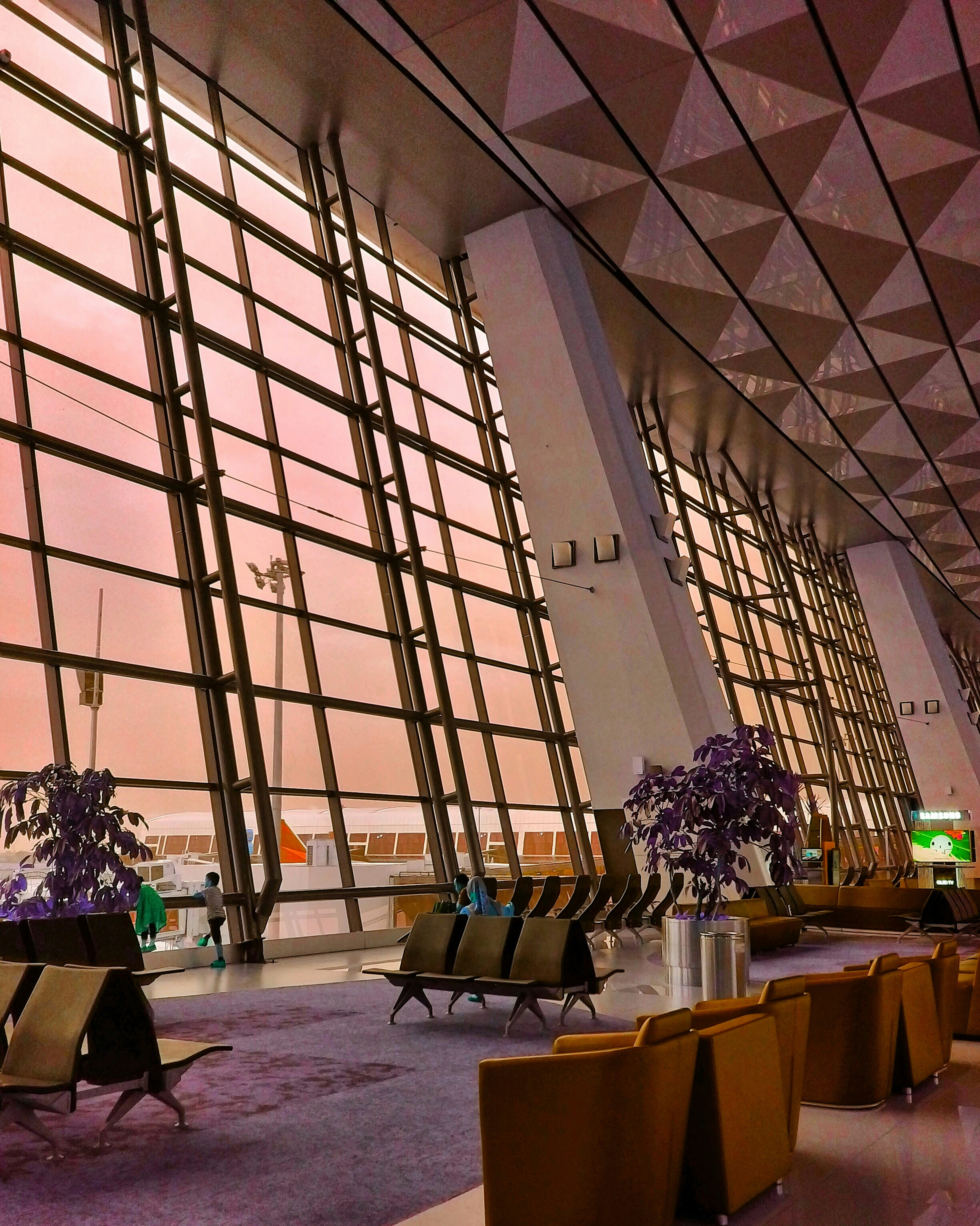 A large building with a lot of windows and chairs