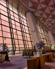 A large building with a lot of windows and chairs