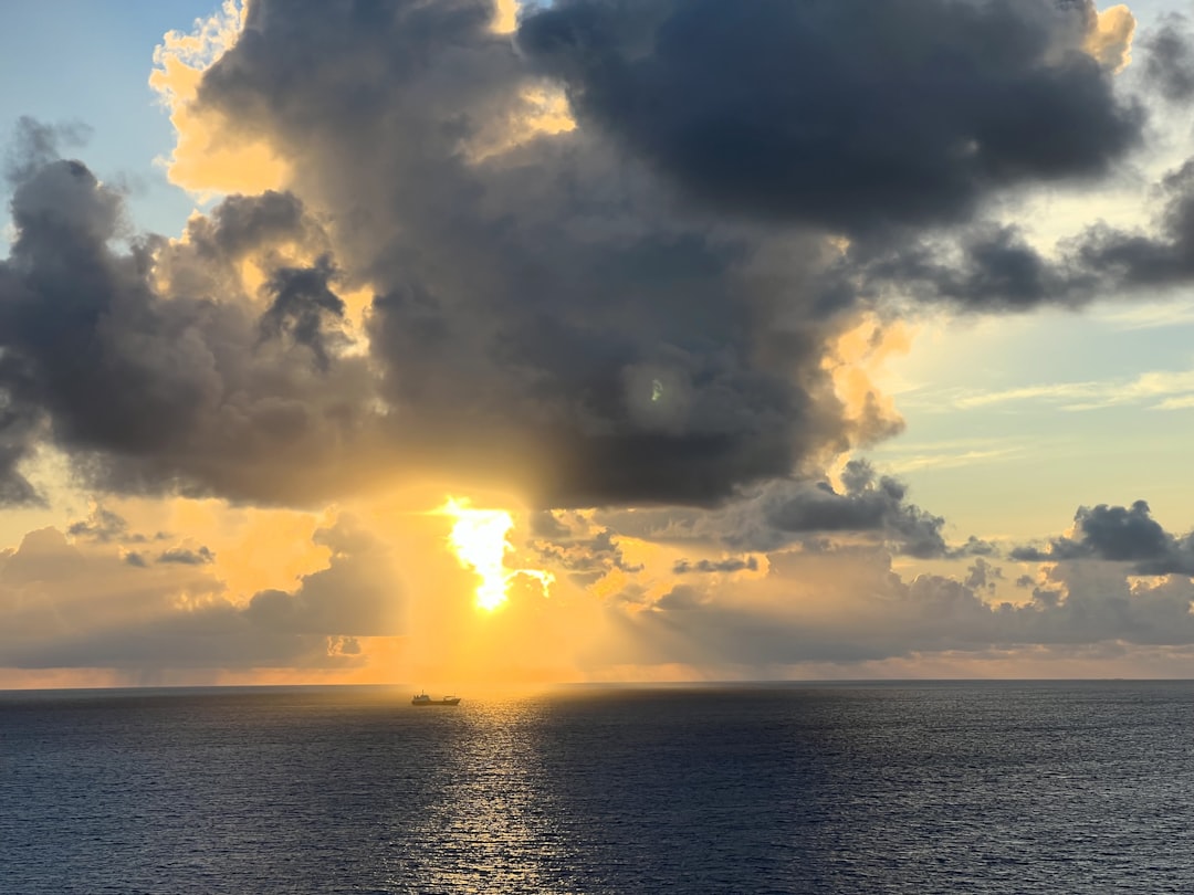 A large body of water under a cloudy sky,