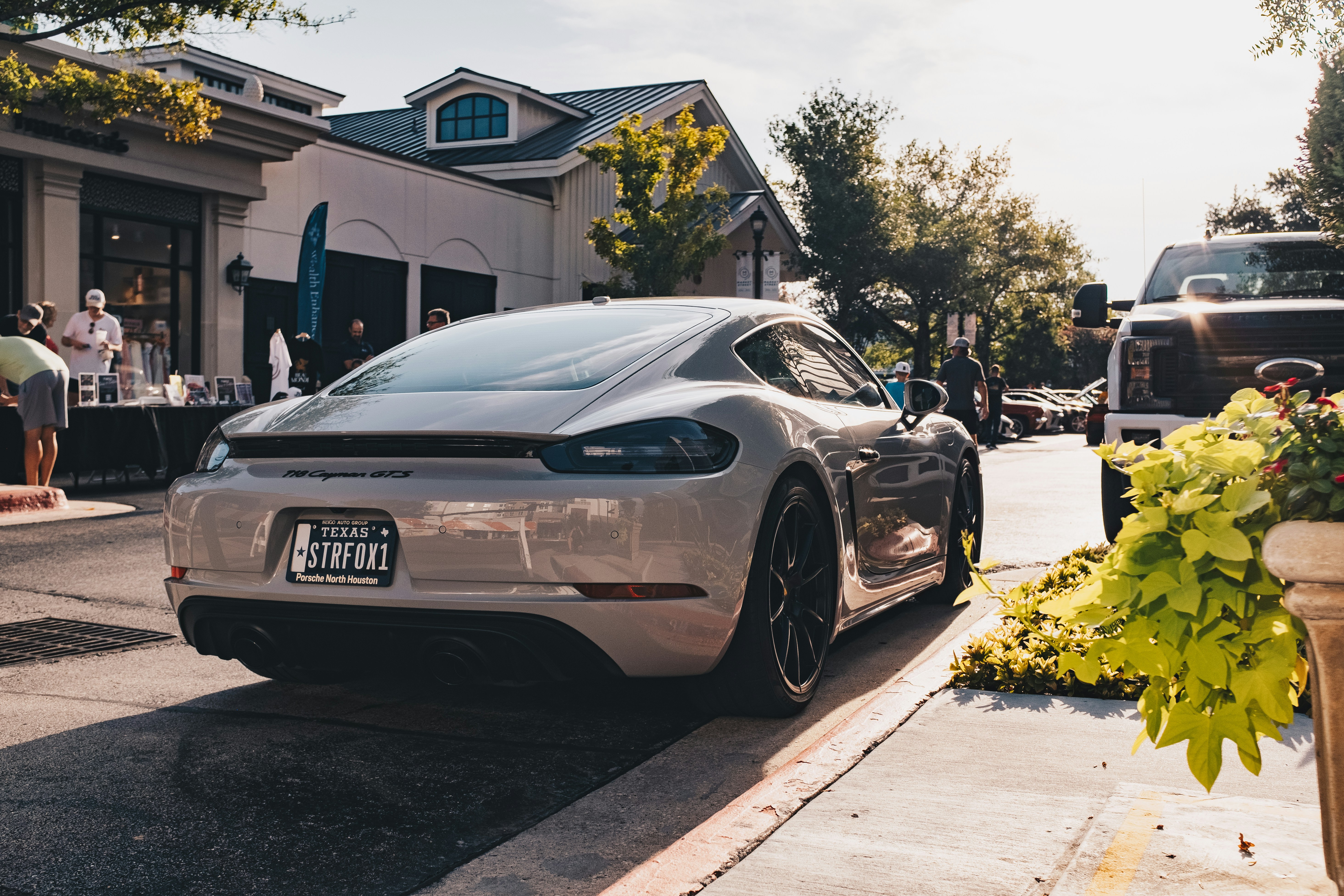 Lineup of modern electric vehicles from multiple brands parked in an American setting